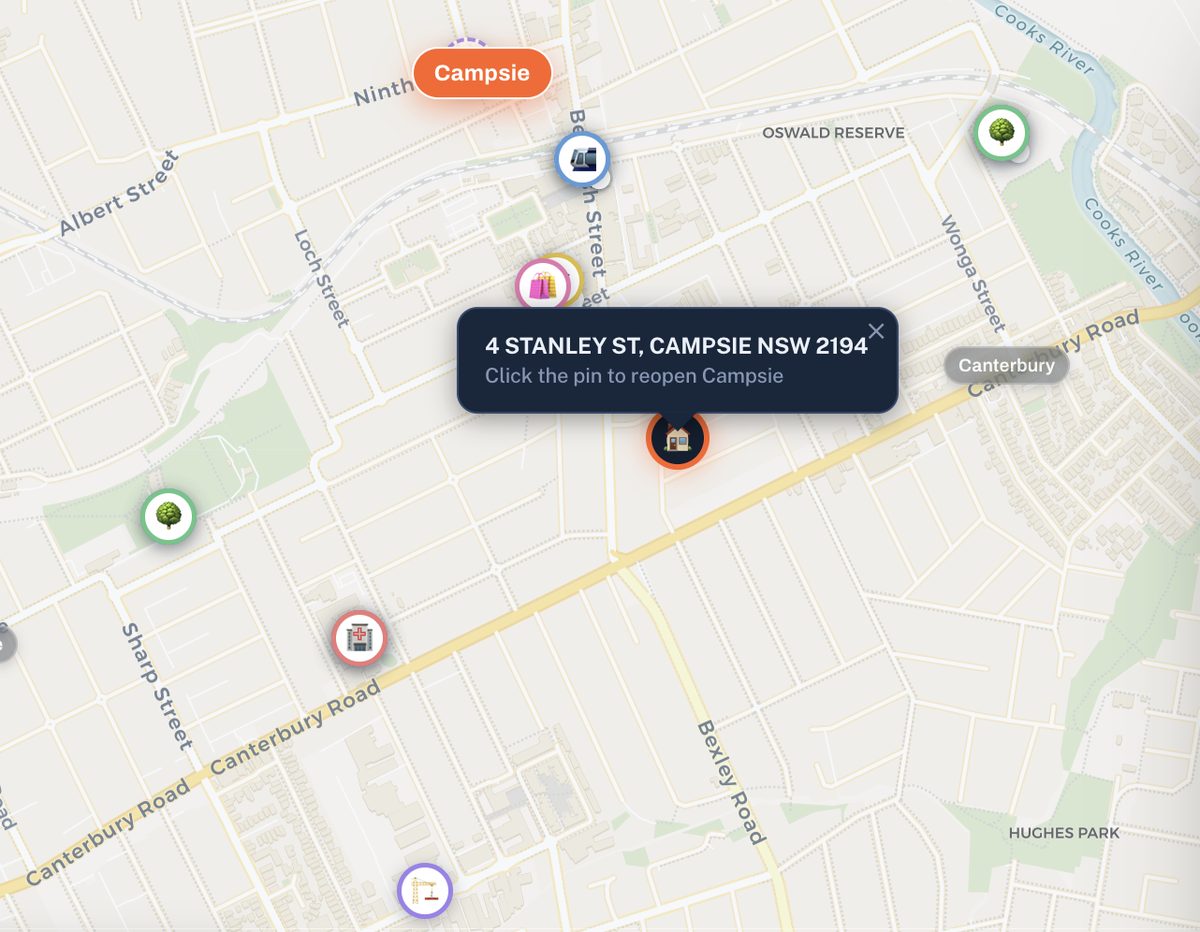 A pin dropped on a street address showing surrounding schools, health, retail and parks